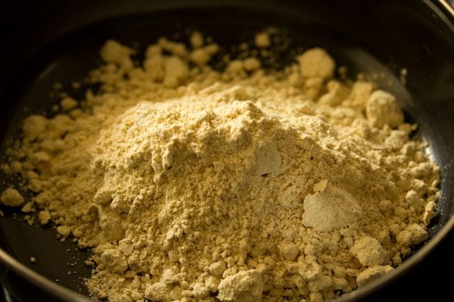 roasted sattu flour added to a bowl. 