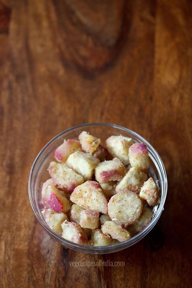 sweet potato chaat served in a glass bowl with text layovers. 