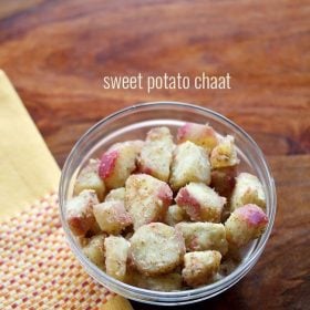 sweet potato chaat snack in a glass bowl with yellow embroidered napkin on left side with text layovers.