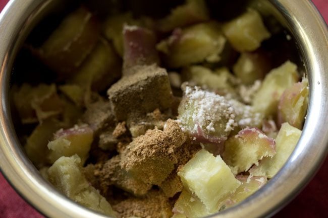 black pepper powder, dried mango powder and rock salt added to the sweet potatoes for making shakarkandi chaat. 