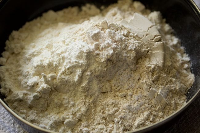all purpose flour, whole wheat flour, baking powder and salt added to a mixing bowl. 