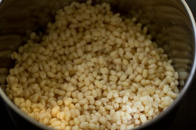 drained urad dal added to a grinder jar. 