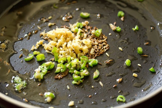 chopped ginger and chopped green chili added to the ghee in the pan. 