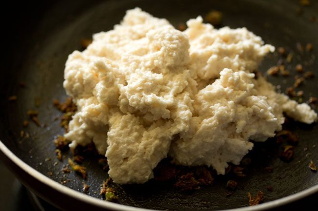 prepared urad dal paste added to the pan. 