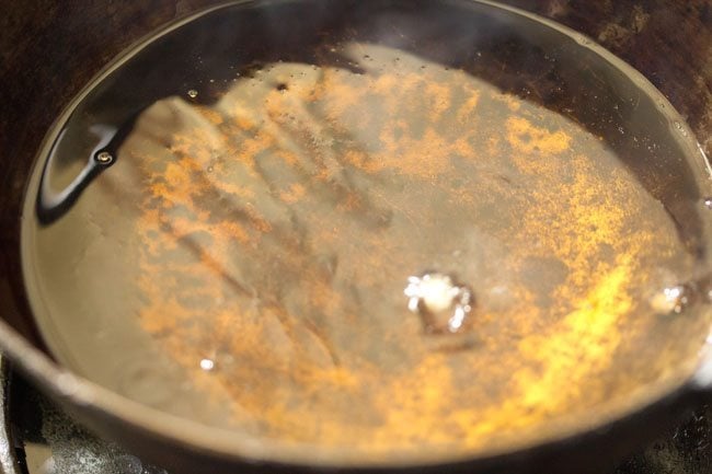 checking the temperature of the hot oil in order to fry the kachoris. 