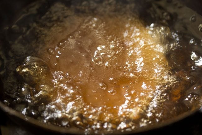 frying a kachori in hot oil. 
