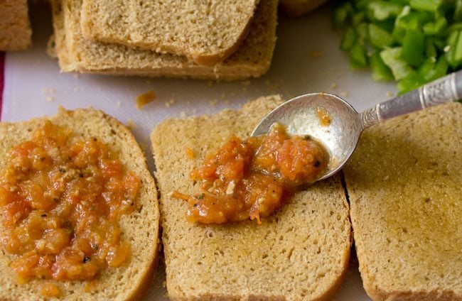 spread pizza sauce on bread slices