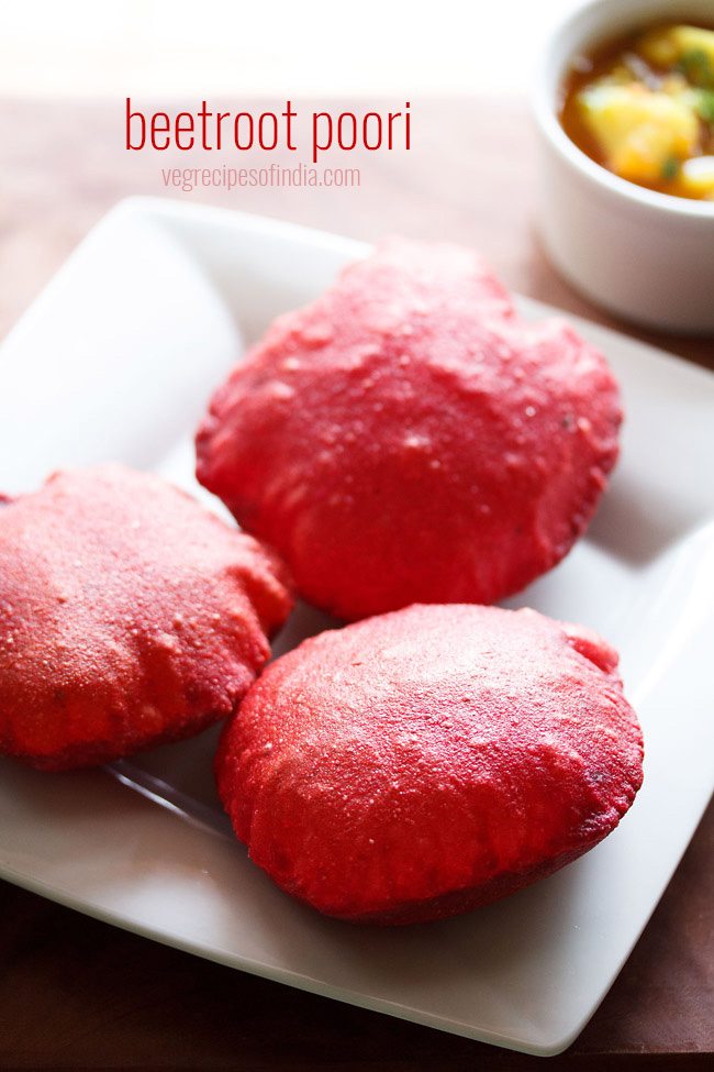 beetroot poori served on a white plate with a side of potato curry