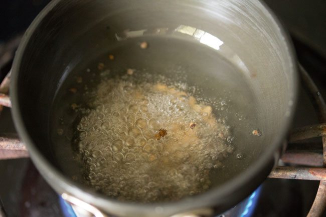 frying mustard seeds and urad dal in hot coconut oil. 