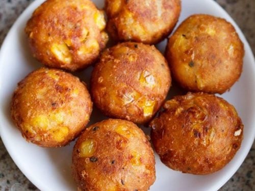 cheese corn balls on a white plate.
