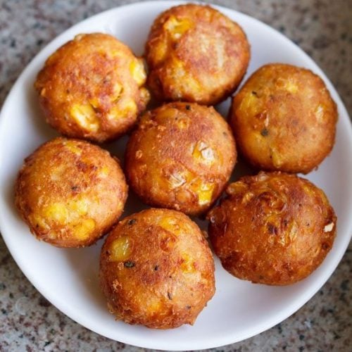 cheese corn balls on a white plate.