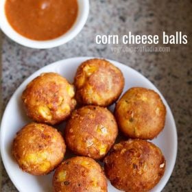 cheese corn balls in a white plate with a chilli dipping sauce.