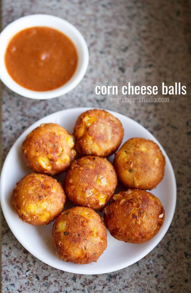 cheese corn balls in a white plate with a chilli dipping sauce.
