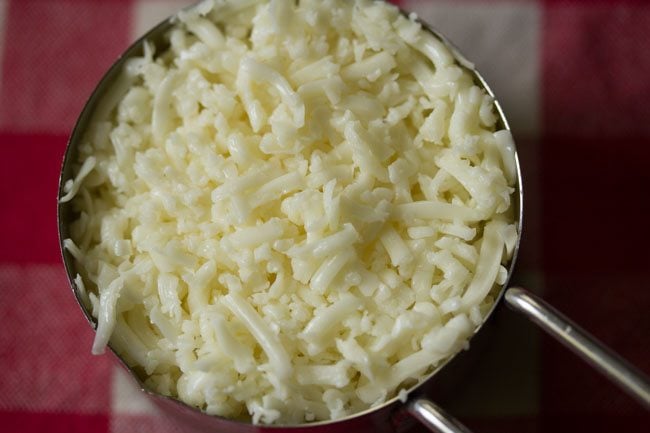 shredded cheese in a measuring cup.