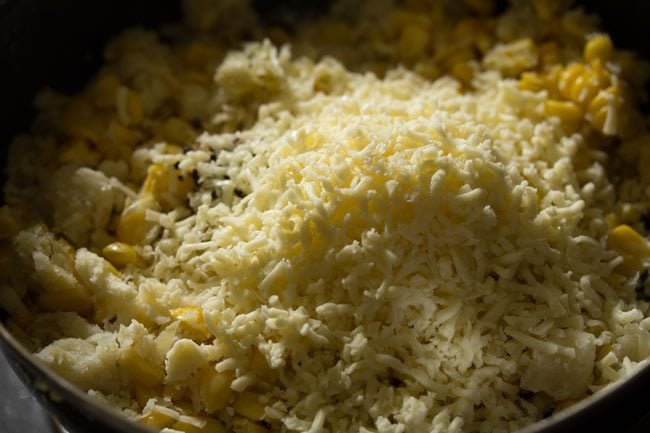 mound of grated cheese over corn and potato mixture.