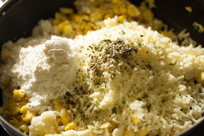 all purpose flour and dried herbs in bowl over the mound of grated cheese.