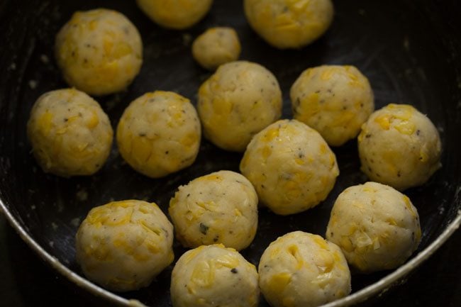 many balls of cheese corn mixture placed in bowl.