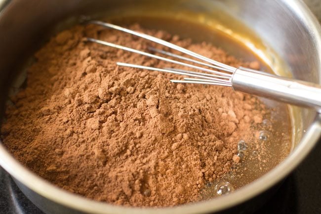 adding cocoa powder to the milk-sugar mixture 