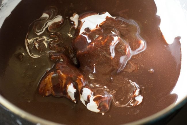 adding chocolate mixture to whipped cream 