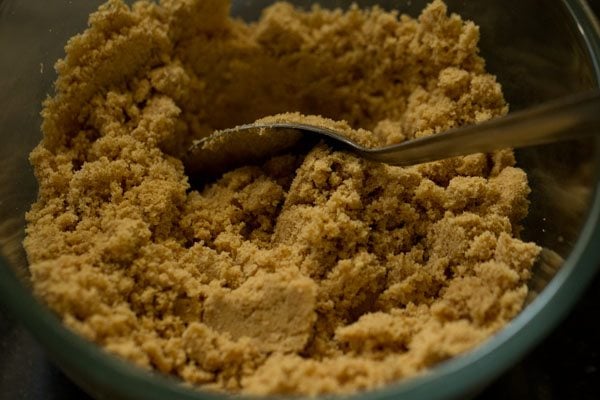 spoon in a mixing bowl with cheesecake crust ingredients