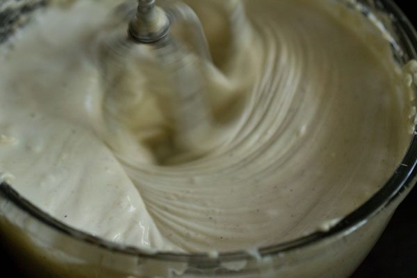 beating the cheesecake filling with an electric mixer
