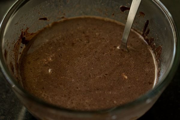 spoon stirring chocolate and milk mixture until smooth 