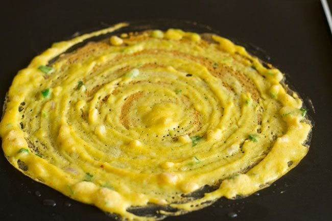 cooking moong dal chilla. 