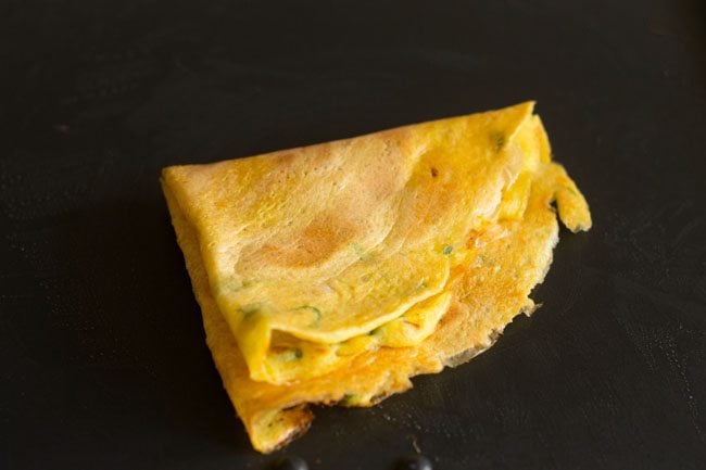 moong dal chilla folded into a triangular shape. 