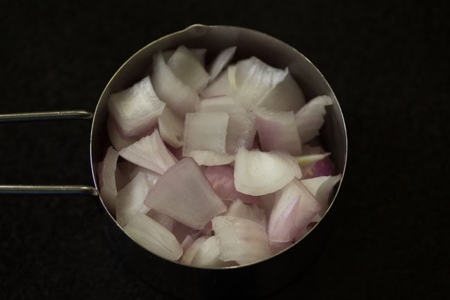 cubes onions in a measuring cup