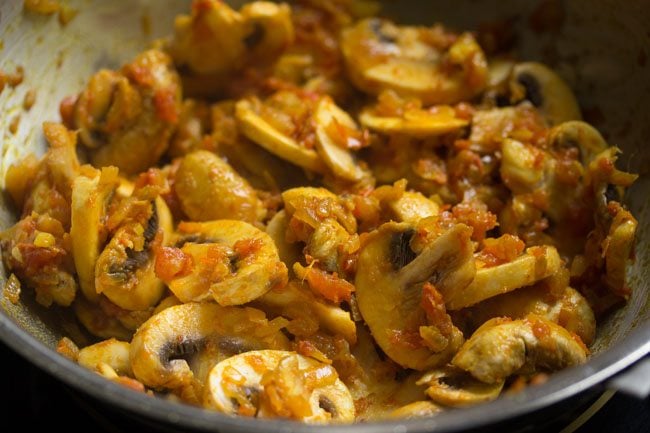 button mushrooms mixed with the onion and tomato masala