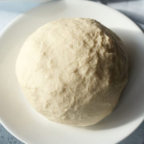 no yeast pizza dough on a white plate on a light blue napkin.