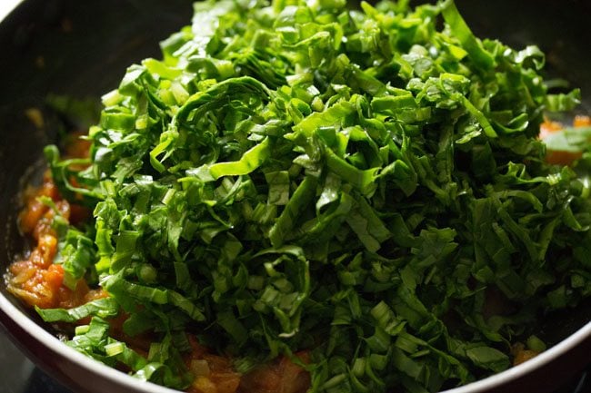 chopped spinach added to masala