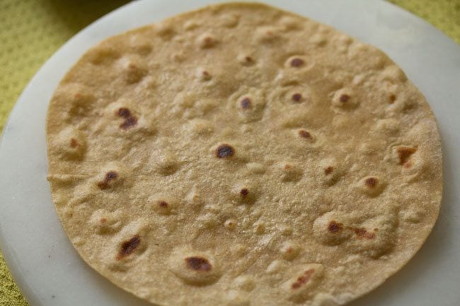 cooked roti on a white board