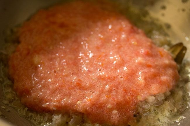prepared tomato puree added to pan. 