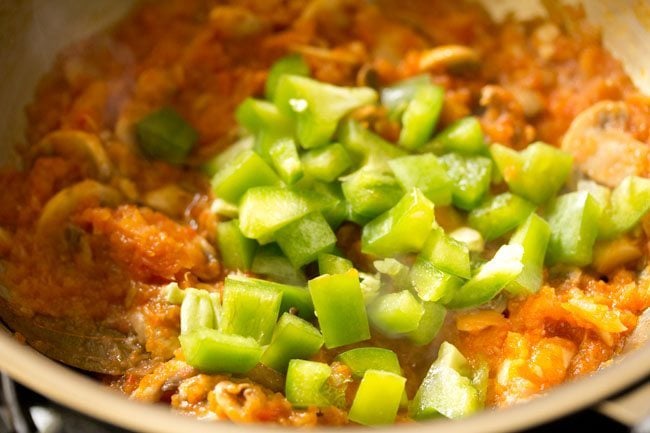 chopped capsicum added to pan. 