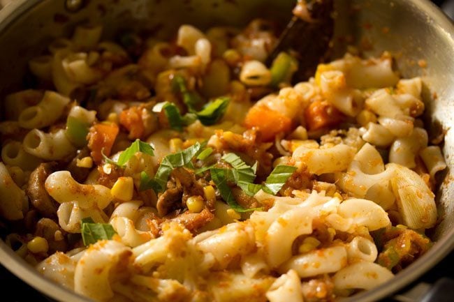 chopped fresh basil leaves added to red sauce pasta. 