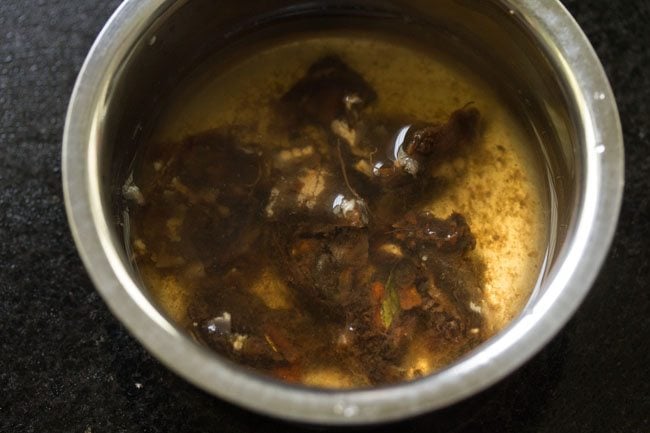 soaking tightly packed tamarind in water. 