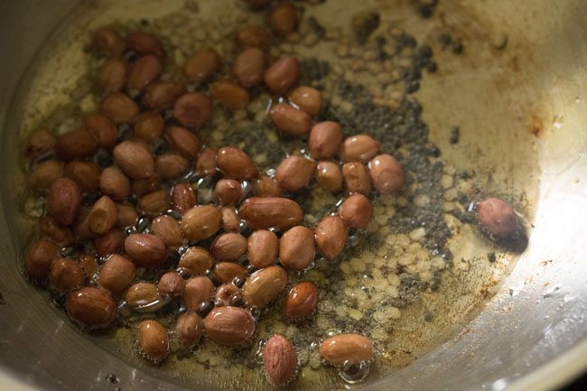 roasted peanuts added to the hot oil in pan. 