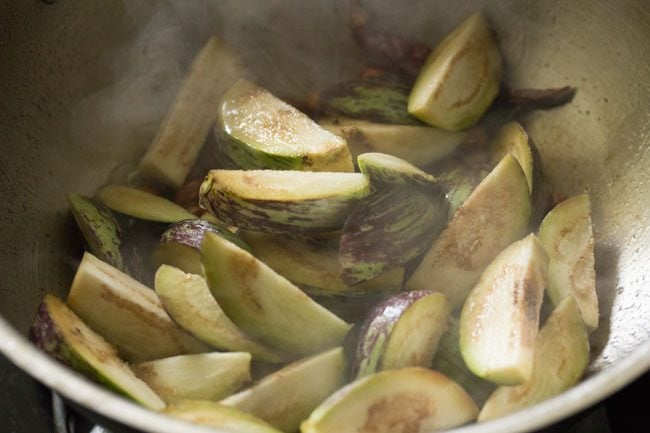 brinjal pieces added to the pan. 