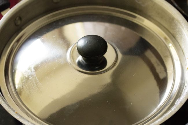 pan covered with a lid to half cook the brinjals. 