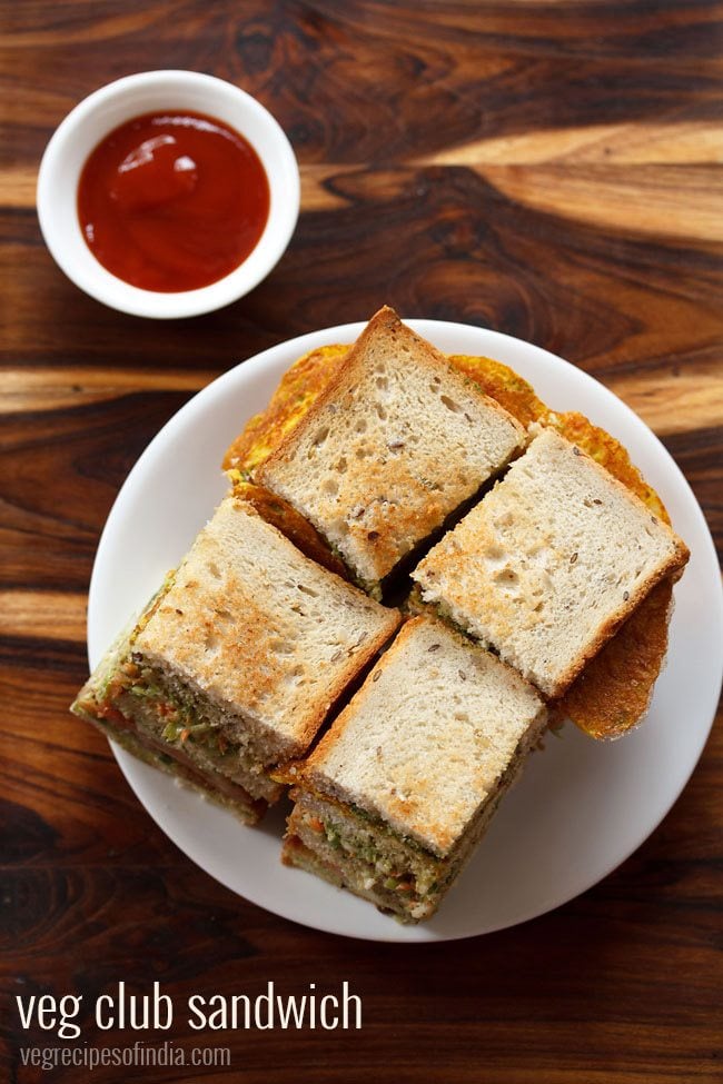 club sandwiches squares in a white plate with tomato ketchup 