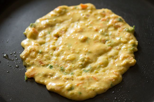 chilla batter on a frying pan