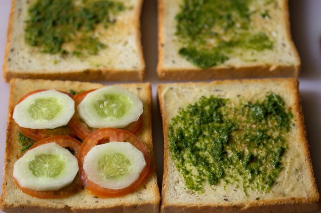 thinly sliced cucumbers and tomatoes  on toasted bread