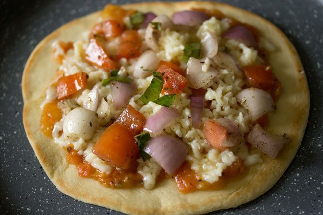 topping the sauce with marinated vegetables 