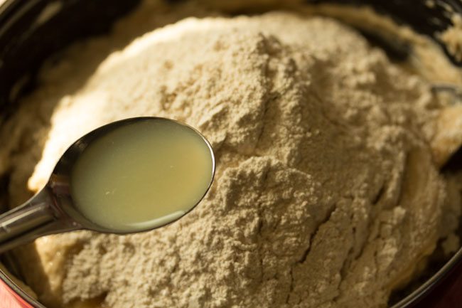 adding lemon juice to flour. 