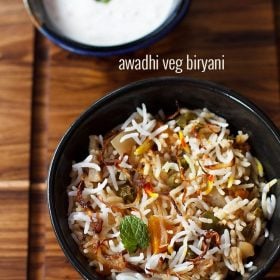 Lucknowi biryani served in a bowl with a side of raita