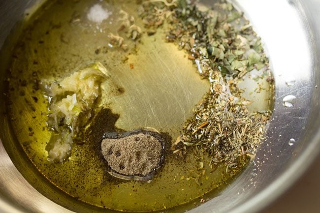 black pepper powder, oregano, basil, thyme, garlic, salt and oil in a bowl