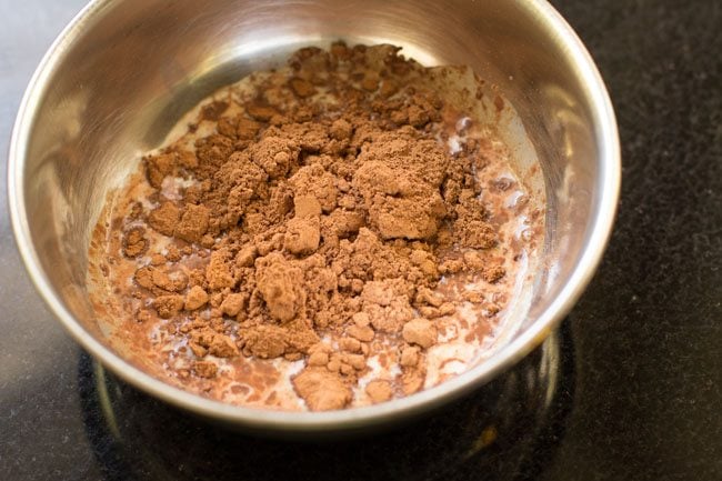 adding cocoa powder to the milk 