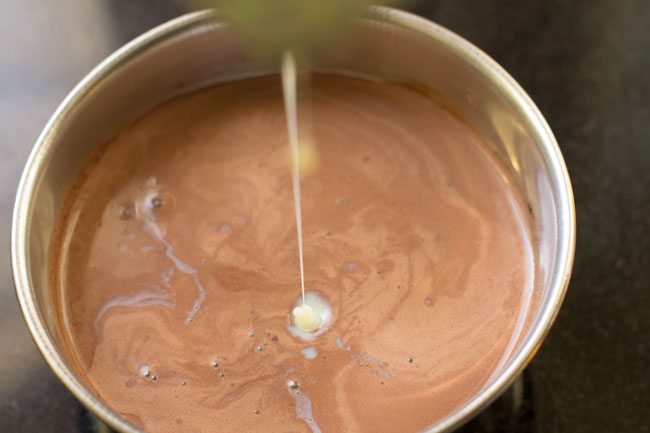 adding condensed milk to the chocolate-milk mixture 