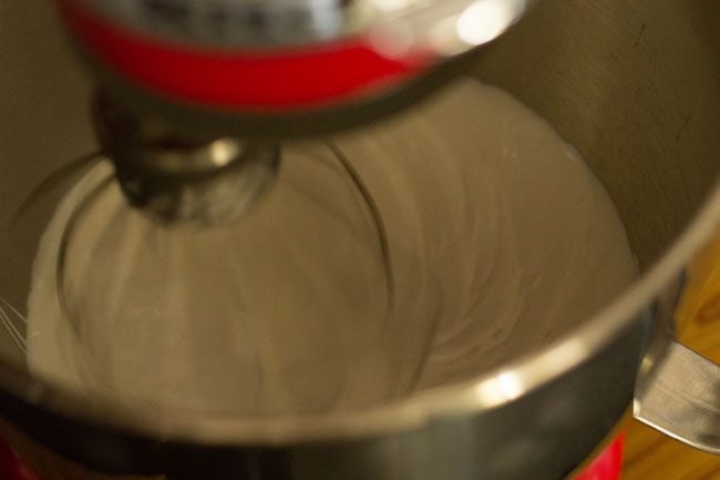 chilled cream in a stand mixer getting whipped 